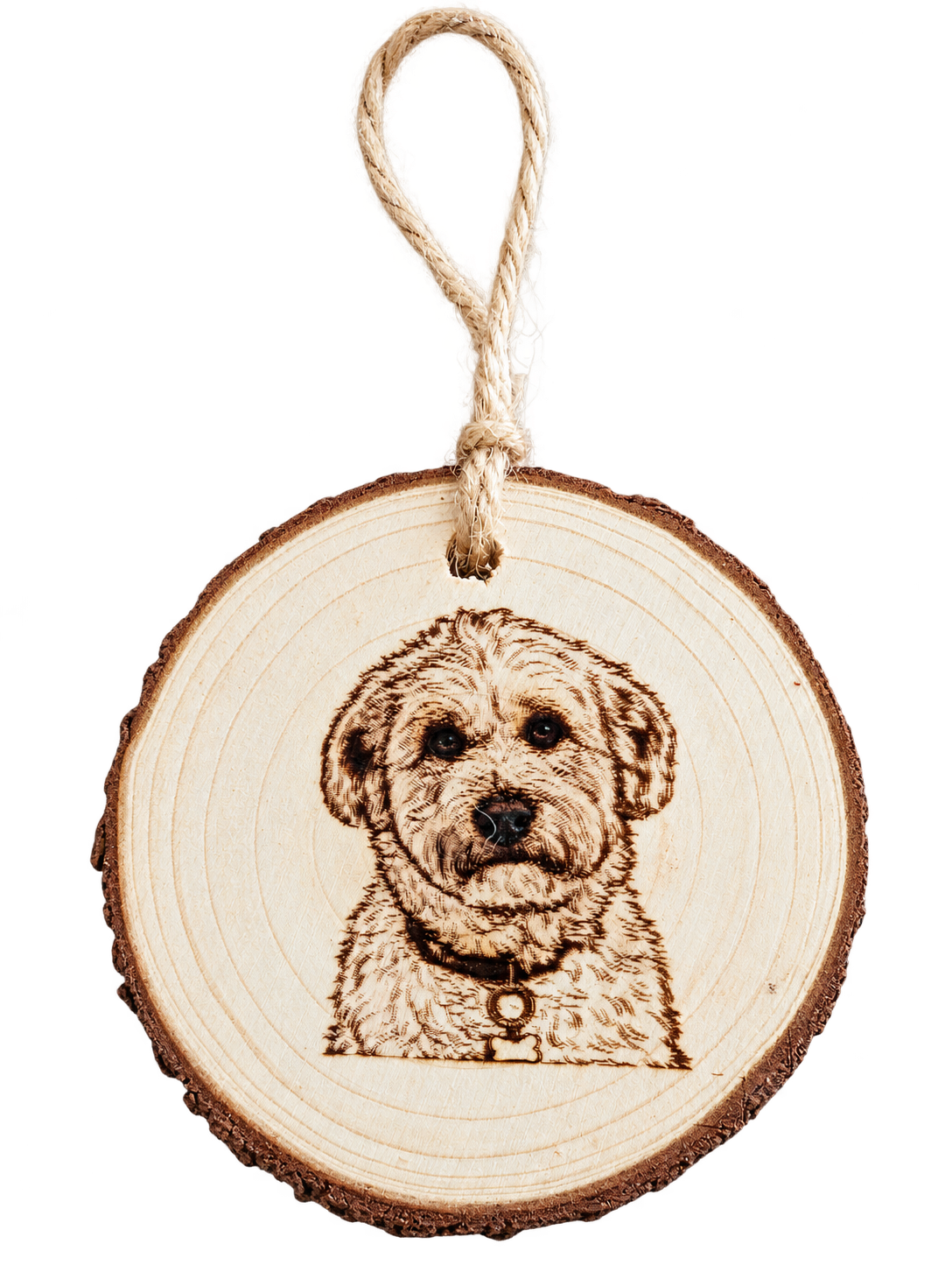 A dog portrait engraved on a hanging wooden Christmas ornament